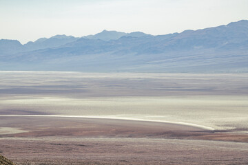 A desert landscape with a river running through it