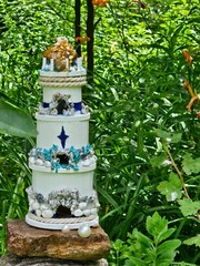Lighthouse in the forest resting on stones