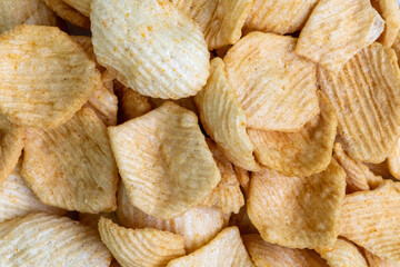 Spicy potato crackers chips background.