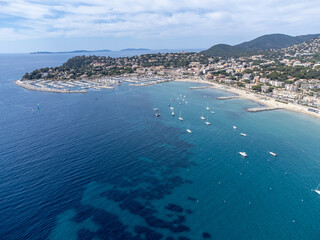 Aerial view on boats, crystal clear blue water of Plage du Debarquement white sandy beach near Cavalaire-sur-Mer and La Croix-Valmer, summer vacation on French Riviera, Var, France