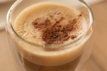 Transparent double-glass cup of coffee cappuccino