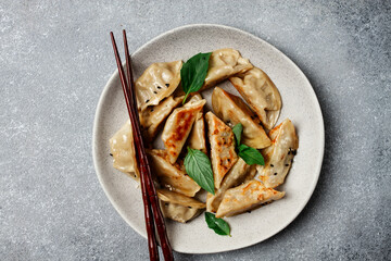 japanese fried gyoza dumplings, with pork, sesame seeds, green onions,