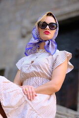 Beautiful woman with blue eyes dressed in the 1920s in the Barcelona cathedral