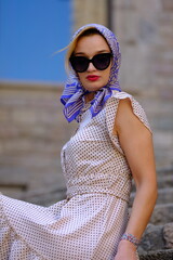 Beautiful woman with blue eyes dressed in the 1920s in the Barcelona cathedral
