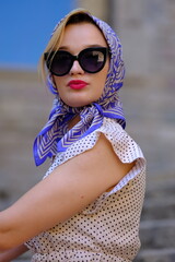 Beautiful woman with blue eyes dressed in the 1920s in the Barcelona cathedral