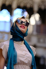 Beautiful woman with blue eyes dressed in the 1920s in the Barcelona cathedral