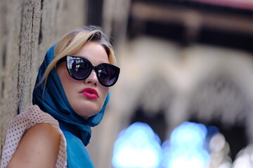 Beautiful woman with blue eyes dressed in the 1920s in the Barcelona cathedral