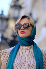 Beautiful woman with blue eyes dressed in the 1920s in the Barcelona cathedral