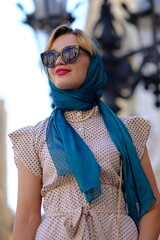 Beautiful woman with blue eyes dressed in the 1920s in the Barcelona cathedral