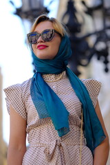 Beautiful woman with blue eyes dressed in the 1920s in the Barcelona cathedral