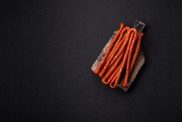 Mini sausages or cabanosi smoked with salt and spices