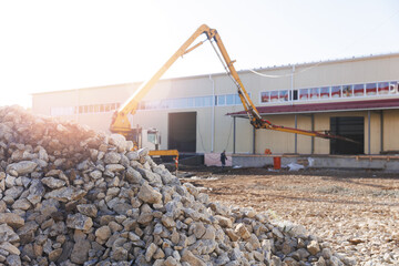 Obraz premium Concrete pump working on construction building site, sunlight