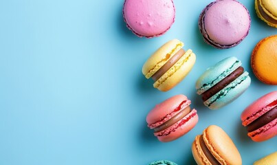 Obraz premium A blue background with a variety of colorful macarons.
