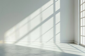 A spacious, bright room with minimalist decor. Soft shadows play across the walls, creating a tranquil atmosphere