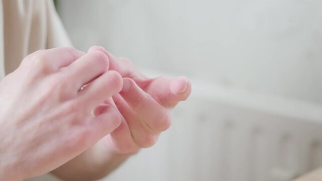 Male fingers closeup, man performing self-administered medical test pricking finger and collecting blood in tube, rapid diagnostic at-home test, blood sample collection, DIY medical test