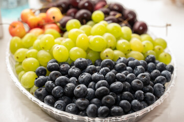 Fruit tray of blue berries, grapes, and cherries are a refreshing way to consume vitamin