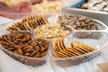 Snack tray of almonds, peanuts, and crackers is a healthy way to eat between meals