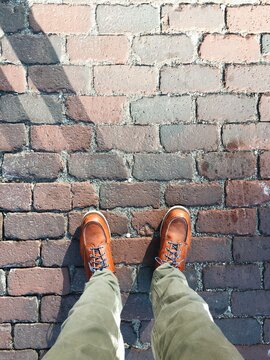 urban city hipster leather hiking boots on cobblestone street