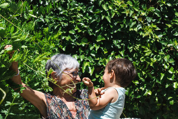 Obraz premium Grandmother and grandson laughing in the garden