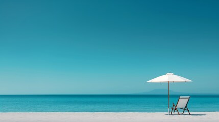 Serene beach scene with a lounge chair and umbrella under a clear blue sky, perfect for a relaxing coastal getaway.