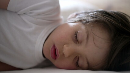 Child stretching and waking up from a nap, capturing the transition from sleep to wakefulness, with a relaxed and sleepy expression, showcasing the peacefulness of rest