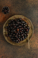 black currant berry on a metal plate