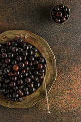 black currant berry on a metal plate