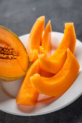 Melon Charentais sweet fruit fresh appetizer meal food snack on the table copy space food background rustic top view keto or paleo diet vegetarian vegan food