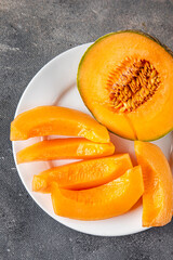 Melon Charentais sweet fruit fresh appetizer meal food snack on the table copy space food background rustic top view keto or paleo diet vegetarian vegan food