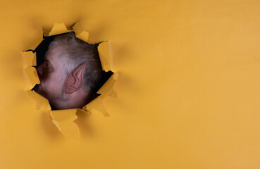 ear in a yellow paper hole