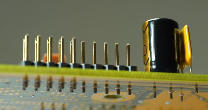 Computer microcircuit with electronic components, resistors and connection terminals, close-up shot