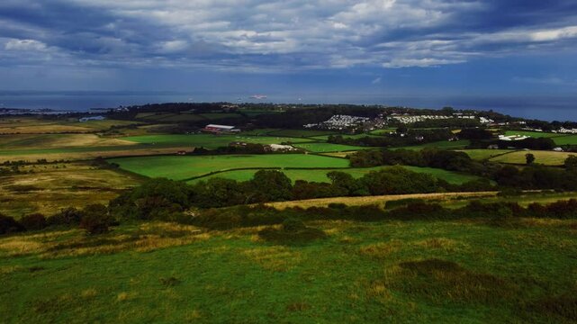 Drone footage of the green rolling fields near Bembridge village in the Isle of Wight, England, UK