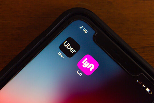 Vancouver, CANADA - Jul 15 2024 : Uber and Lyft apps seen in an iPhone screen. Leading ridesharing companies concept image