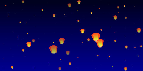 Sky lanterns floating in the night sky.