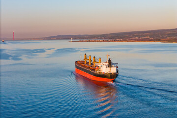 Dry bulk cargo ship underway in sea, a merchant ship to transport bulk cargo. Aerial view