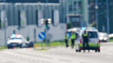 Two police cars and police officers in action. Blurred police scene. Czech police stock photo.