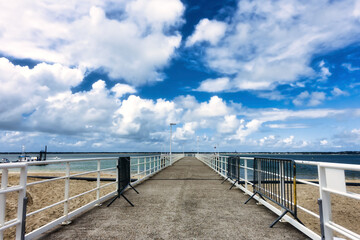 Obraz premium Shot of a wide beach with clouds reflecting in the water and blue sky