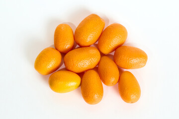 Group of Fresh Orange Kumquats on a White Background