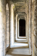 a corridor walkway along the inside of a medieval castle wall