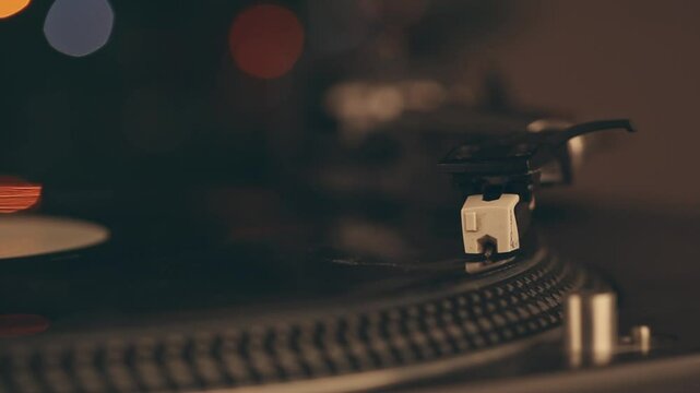 DJ headshell on spinning turntable. Listening the music on vinyl. Closeup
