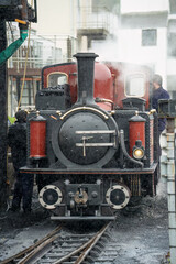 Naklejka premium a vintage steam locomotive train preparing for departure, the Ffestiniog Railway, Porthmadog, Wales