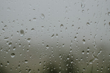 raindrops on the window during a strong hurricane with wind in nature