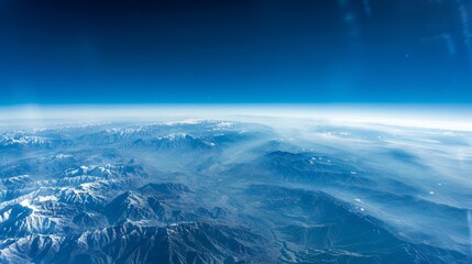 Fototapeta premium A high-altitude view of the Earth from an airplane window, providing a breathtaking perspective with room for text