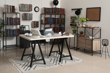 Vintage typewriter with crumpled paper sheets and books on table in office
