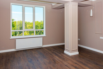 A large room with a window and a radiator