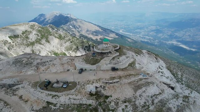 Aerial view of Mount Tomorr is situated within the Tomorr National Park with Shrine (tyrbe) of Abbas ibn Ali on the top in Summer, Albania - raw file