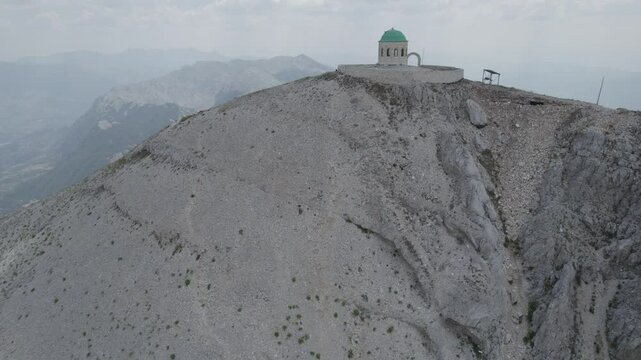 Aerial view of Mount Tomorr is situated within the Tomorr National Park with Shrine (tyrbe) of Abbas ibn Ali on the top in Summer, Albania - raw file