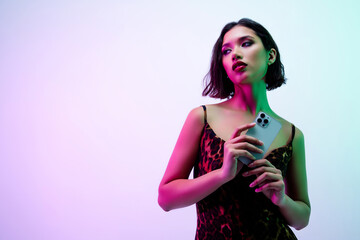 Photo of teasing sensual lady wear dress texting modern gadget empty space isolated pink color...