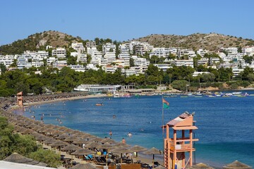 July 9, 2024, Vouliagmeni, Greece. View of the beach, bay and town at the Kavouri resort area, on a...