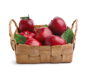Wicker basket with fresh red apples and leaves on white background